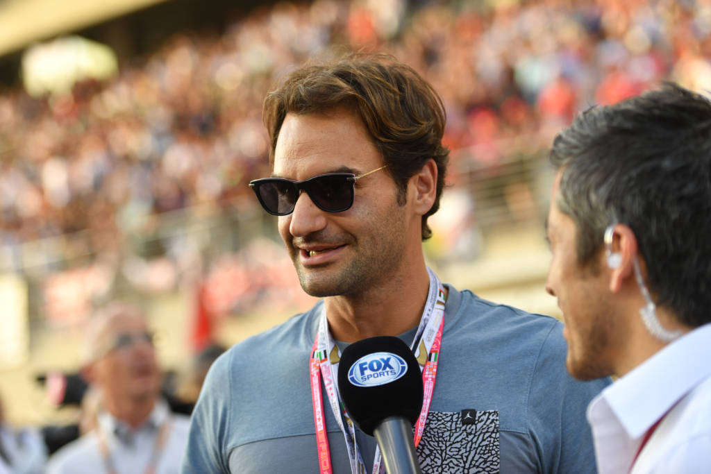 Swiss tennis champion Roger Federer talks to journalists as he attends the Abu Dhabi Formula One Grand Prix at the Yas Marina circuit on November 27, 2016. / AFP PHOTO / Andrej ISAKOVIC