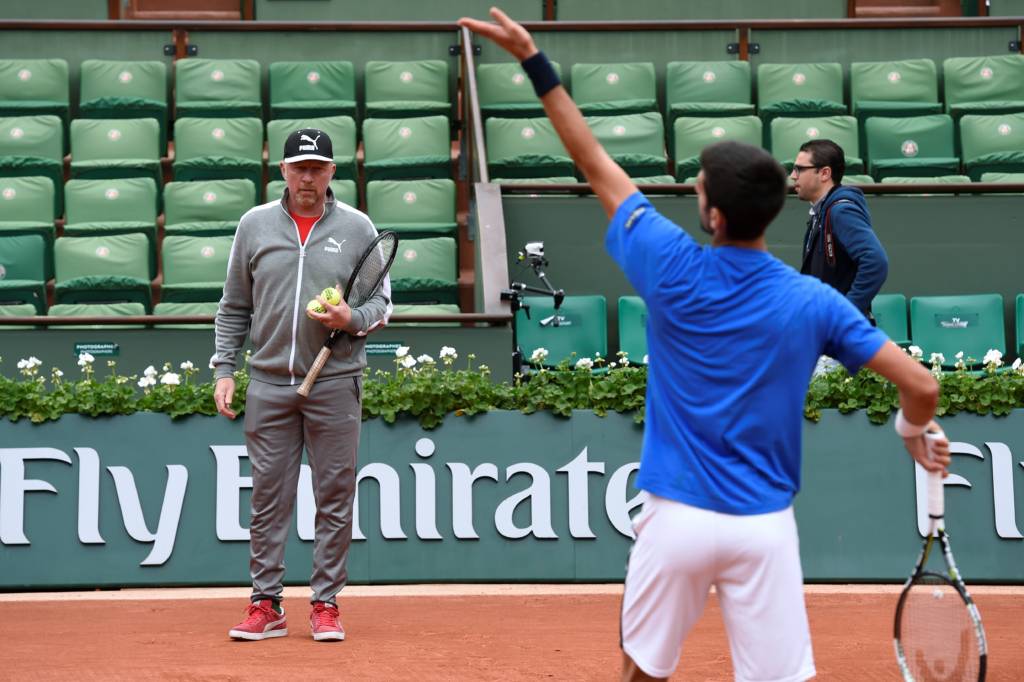 (FILES) This file photo taken on June 4, 2016 shows Serbia's Novak Djokovic training with his coach Boris Becker at the Roland Garros 2016 French Tennis Open in Paris. World number two Novak Djokovic confirmed on December 6, 2016 he has split from his coach Boris Becker after three years working together. "Boris Becker and I have jointly decided to end our cooperation," Djokovic, who won this year's Australian and French Open titles, wrote on his official Facebook page.  / AFP PHOTO / MIGUEL MEDINA