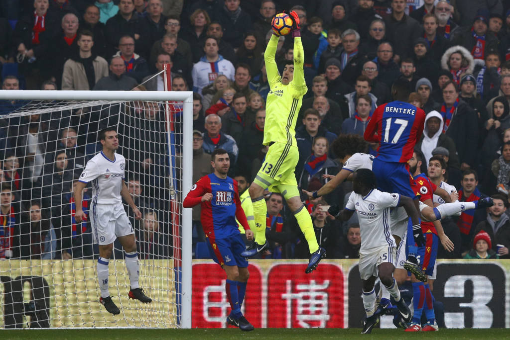 Chelsea's Belgian goalkeeper Thibaut Courtois (C) jumps to save a shot by Crystal Palace's Zaire-born Belgian striker Christian Benteke during the English Premier League football match between Crystal Palace and Chelsea at Selhurst Park in south London on December 17, 2016. / AFP PHOTO / Adrian DENNIS / RESTRICTED TO EDITORIAL USE. No use with unauthorized audio, video, data, fixture lists, club/league logos or 'live' services. Online in-match use limited to 75 images, no video emulation. No use in betting, games or single club/league/player publications.  /