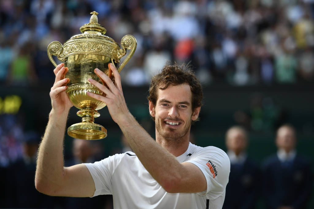 (FILES) This file photo taken on July 10, 2016 shows Britain's Andy Murray posing with the winner's trophy after his men's singles final victory over Canada's Milos Raonic on the last day of the 2016 Wimbledon Championships at The All England Lawn Tennis Club in Wimbledon, south west London. Wimbledon champion Andy Murray and Olympic gold medallist Mo Farah will each receive a knighthood in the New Year Honours. Murray's knighthood caps a dream season for the Scot, who finished as the year-end world number one for the first time after ending Novak Djokovic's long spell at the top. / AFP PHOTO / GLYN KIRK / RESTRICTED TO EDITORIAL USE