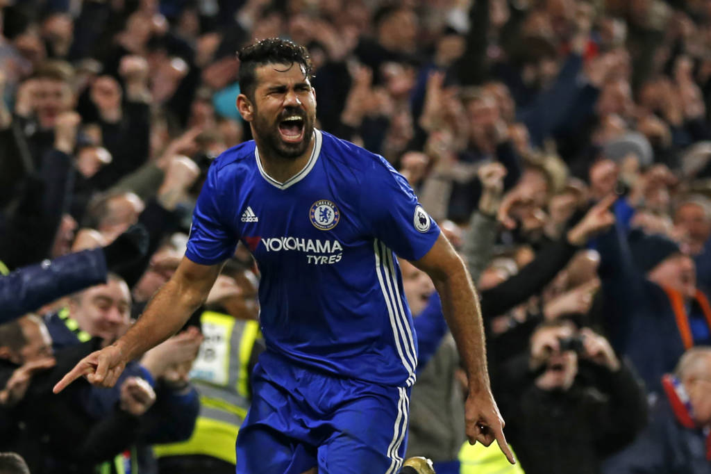 Chelsea's Brazilian-born Spanish striker Diego Costa celebrates after scoring their fourth goal during the English Premier League football match between Chelsea and Stoke City at Stamford Bridge in London on December 31, 2016. Chelsea won the game 4-2. / AFP PHOTO / Ian KINGTON / RESTRICTED TO EDITORIAL USE. No use with unauthorized audio, video, data, fixture lists, club/league logos or 'live' services. Online in-match use limited to 75 images, no video emulation. No use in betting, games or single club/league/player publications. /