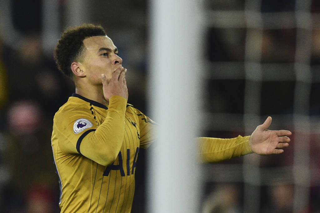 Tottenham Hotspur's English midfielder Dele Alli blow kisses as he celebrates scoring their fourth goal during the English Premier League football match between Southampton and Tottenham Hotspur at St Mary's Stadium in Southampton, southern England on December 28, 2016. / AFP PHOTO / Glyn KIRK / RESTRICTED TO EDITORIAL USE. No use with unauthorized audio, video, data, fixture lists, club/league logos or 'live' services. Online in-match use limited to 75 images, no video emulation. No use in betting, games or single club/league/player publications. /