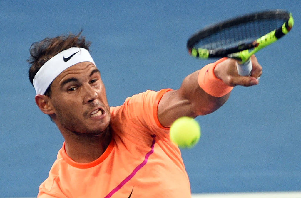 Rafael Nadal of Spain serves against Alexandr Dolgopolov of Ukraine in the men's round one at the Brisbane International tennis tournament in Brisbane on January 3, 2017. / AFP PHOTO / SAEED KHAN / IMAGE STRICTLY RESTRICTED TO EDITORIAL USE  STRICTLY NO COMMERCIAL USE