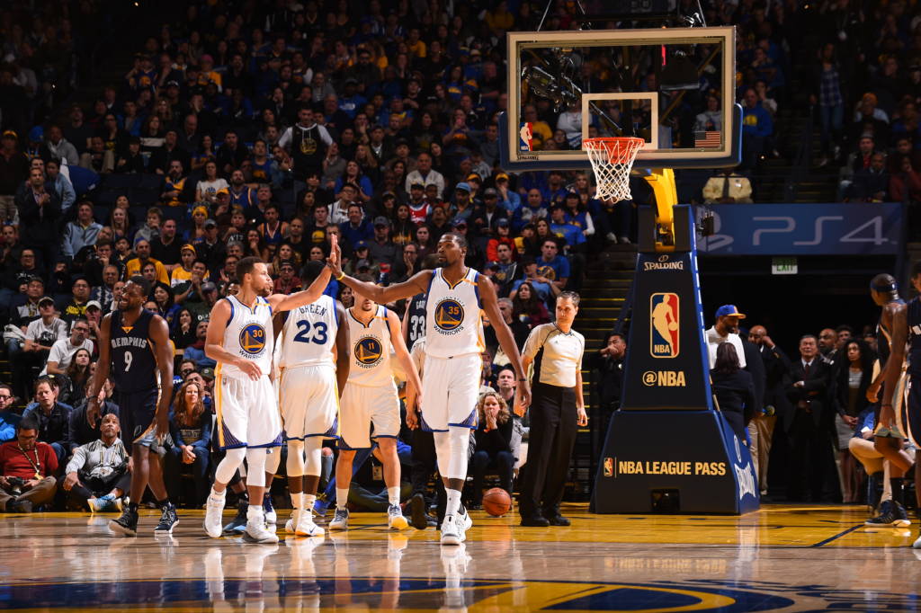 OAKLAND, CA - JANUARY 6: Stephen Curry #30, and Kevin Durant #35 of the Golden State Warriors high five during the game against the Memphis Grizzlies on January 6, 2017 at ORACLE Arena in Oakland, California. NOTE TO USER: User expressly acknowledges and agrees that, by downloading and or using this photograph, user is consenting to the terms and conditions of Getty Images License Agreement. Mandatory Copyright Notice: Copyright 2017 NBAE   Noah Graham/NBAE via Getty Images/AFP