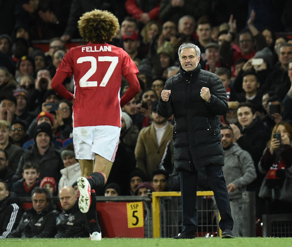Manchester United's Belgian midfielder Marouane Fellaini (L) celebrates scoring his team's second goal with Manchester United's Portuguese manager Jose Mourinho during the EFL (English Football League) Cup semi-final football match between Manchester United and Hull City at Old Trafford in Manchester, north west England on January 10, 2017. / AFP PHOTO / Oli SCARFF / RESTRICTED TO EDITORIAL USE. No use with unauthorized audio, video, data, fixture lists, club/league logos or 'live' services. Online in-match use limited to 75 images, no video emulation. No use in betting, games or single club/league/player publications.  /