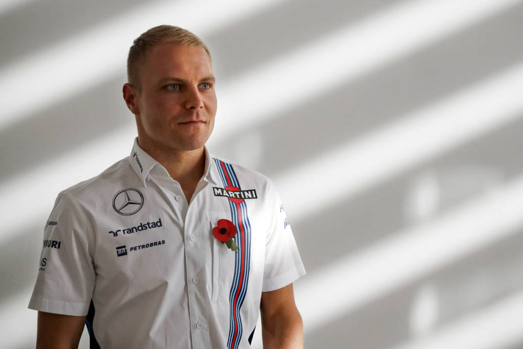 (FILES) This file photo taken on November 03, 2016 shows then Williams Martini Racing team driver, Finn Valtteri Bottas, as he poses for a photograph at the team headquarters in Grove, west of London. The Mercedes Formula One team named on Monday, January 16, 2017 Valtteri Bottas as the new partner for Lewis Hamilton for 2017. The 27-year-old Finn moves from Williams just a few weeks after Nico Rosberg sensationally retired after beating Hamilton to the 2016 title. / AFP PHOTO / Adrian DENNIS