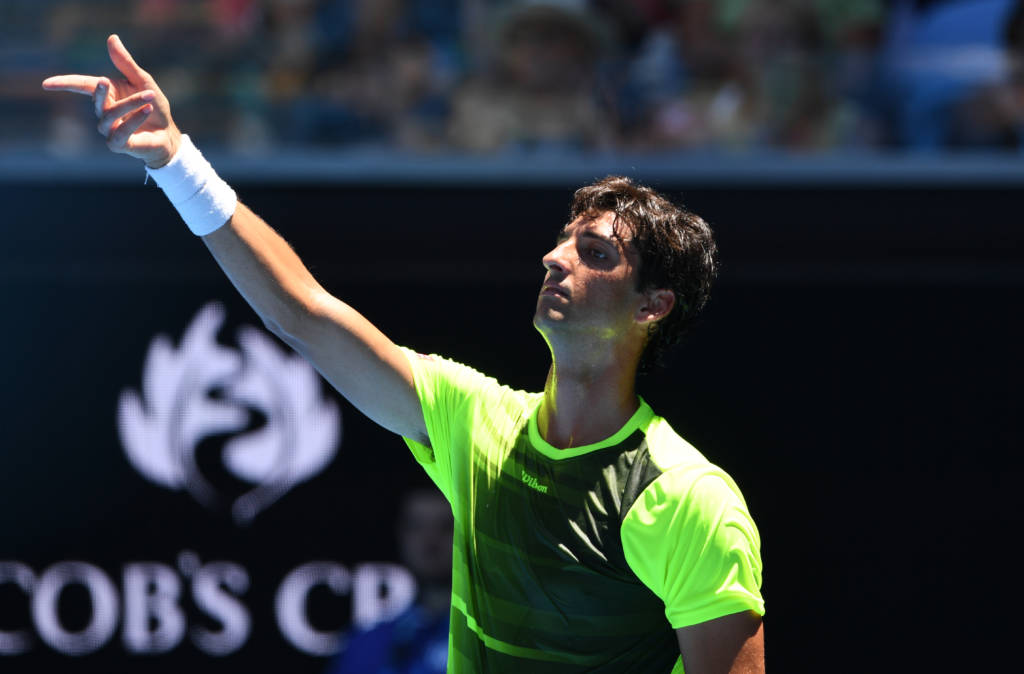 Brazil's Thomaz Bellucci gestures while playing against Australia's Bernard Tomic during their men's singles first round match on day one of the Australian Open tennis tournament in Melbourne on January 16, 2017. / AFP PHOTO / WILLIAM WEST / --IMAGE RESTRICTED TO EDITORIAL USE - STRICTLY NO COMMERCIAL USE--