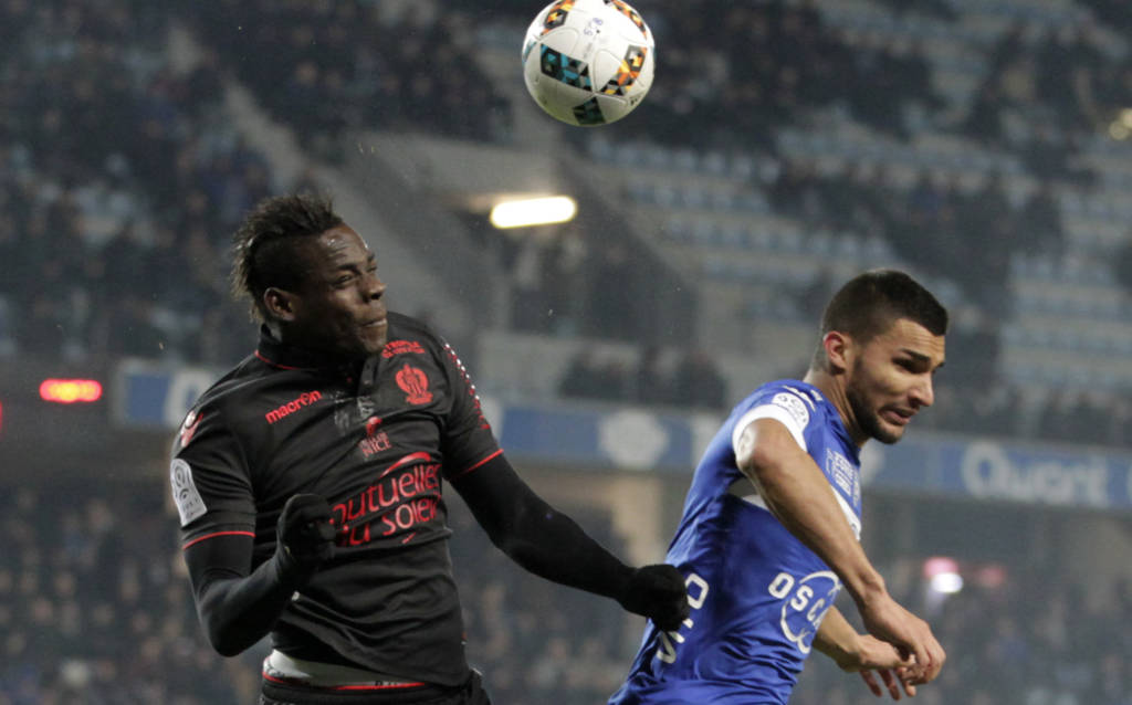 Nice's forward Mario Balotelli vies with Bastia's French defender Lindsay Rose during the L1 football match between Bastia (SCB) and Nice (OGC) on January 20, 2017 at the Armand Cesari stadium in Bastia, on the French Mediterranean island of Corsica.  / AFP PHOTO / PASCAL POCHARD-CASABIANCA