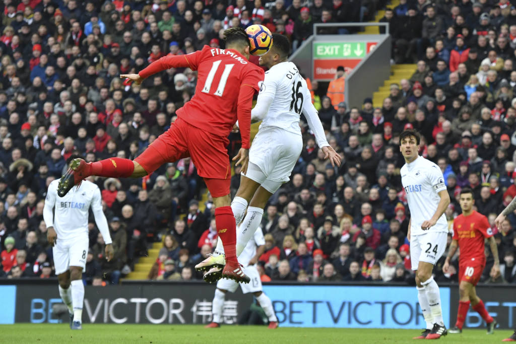 Liverpool's Brazilian midfielder Roberto Firmino (L) heads the ball to score a goal during the English Premier League football match between Liverpool and Swansea City at Anfield in Liverpool, north west England on January 21, 2017. / AFP PHOTO / Anthony DEVLIN / RESTRICTED TO EDITORIAL USE. No use with unauthorized audio, video, data, fixture lists, club/league logos or 'live' services. Online in-match use limited to 75 images, no video emulation. No use in betting, games or single club/league/player publications. /