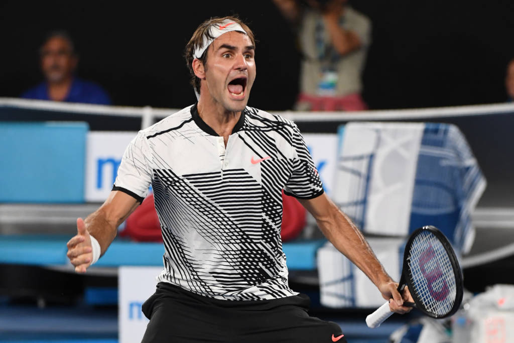 Switzerland's Roger Federer celebrates his victory against Japan's Kei Nishikori during their men's singles fourth round match on day seven of the Australian Open tennis tournament in Melbourne on January 22, 2017. / AFP PHOTO / SAEED KHAN / IMAGE RESTRICTED TO EDITORIAL USE - STRICTLY NO COMMERCIAL USE