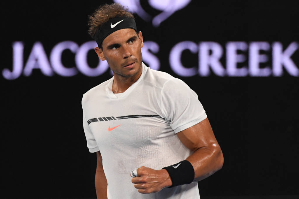 Spain's Rafael Nadal reacts after a point against France's Gael Monfils during their men's singles fourth round match on day eight of the Australian Open tennis tournament in Melbourne on January 23, 2017. / AFP PHOTO / SAEED KHAN / IMAGE RESTRICTED TO EDITORIAL USE - STRICTLY NO COMMERCIAL USE