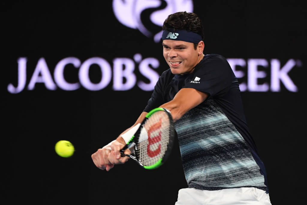 Canada's Milos Raonic hits a return against Spain's Rafael Nadal during their men's singles quarter-final match on day ten of the Australian Open tennis tournament in Melbourne on January 25, 2017. / AFP PHOTO / SAEED KHAN / IMAGE RESTRICTED TO EDITORIAL USE - STRICTLY NO COMMERCIAL USE