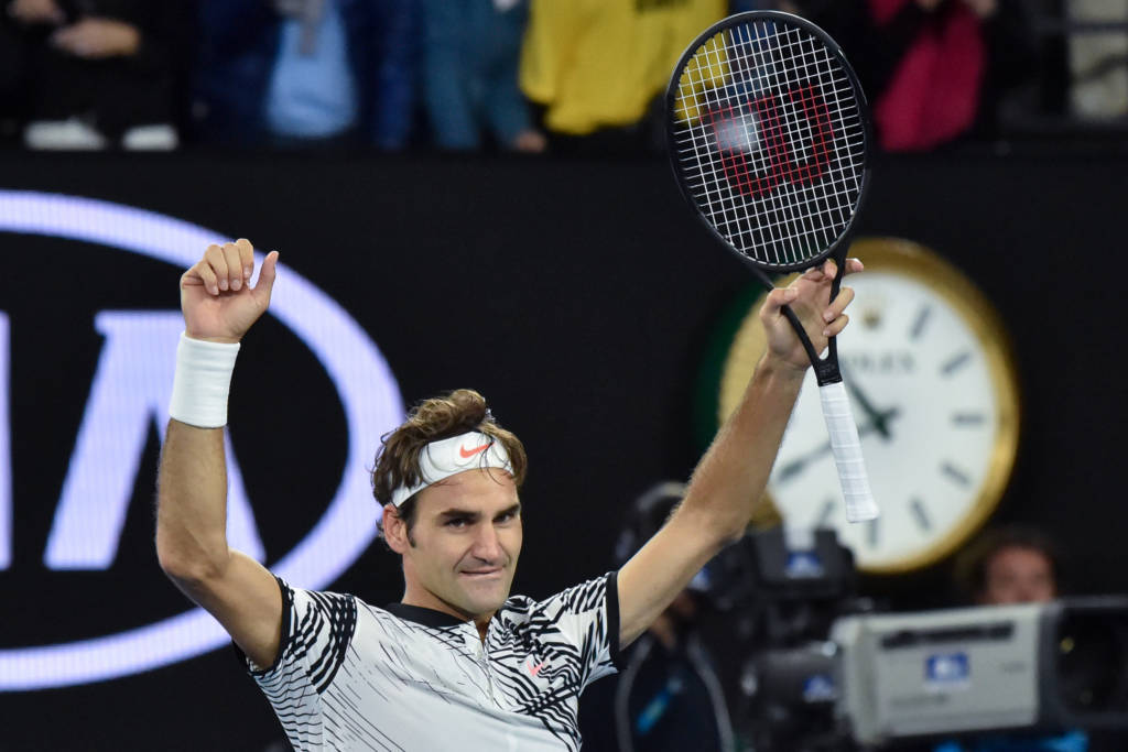 Switzerland's Roger Federer celebrates his victory against Switzerland's Stanislas Wawrinka during their men's singles semi-final match on day 11 of the Australian Open tennis tournament in Melbourne on January 26, 2017. / AFP PHOTO / PETER PARKS / IMAGE RESTRICTED TO EDITORIAL USE - STRICTLY NO COMMERCIAL USE