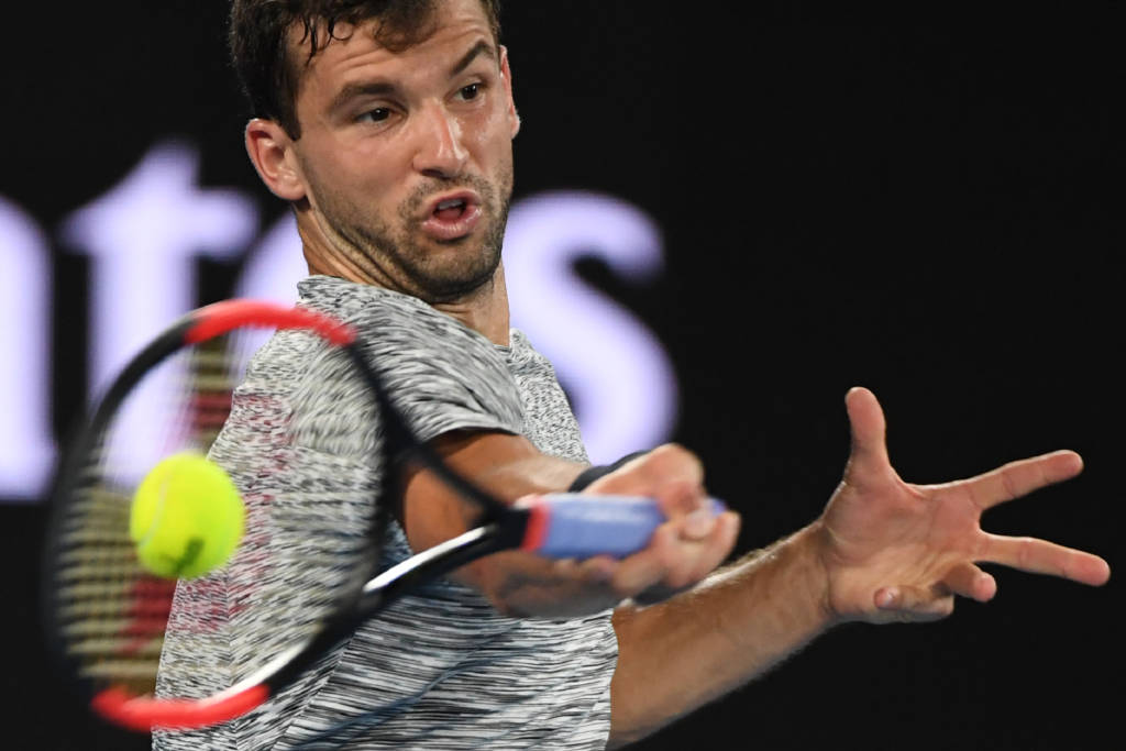 Bulgaria's Grigor Dimitrov hits a return against Spain's Rafael Nadal during their men's singles semi-final match on day 12 of the Australian Open tennis tournament in Melbourne on January 28, 2017. / AFP PHOTO / WILLIAM WEST / IMAGE RESTRICTED TO EDITORIAL USE - STRICTLY NO COMMERCIAL USE