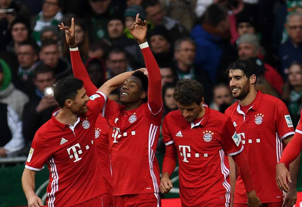 Bayern Munich's Austrian midfielder David Alaba(2nd L) and his teammates celebrate after scoring during the German first division Bundesliga football match of Werder Bremen vs FC Bayern Munich in Bremen, nothern Germany, on January 28, 2017. / AFP PHOTO / PATRIK STOLLARZ / RESTRICTIONS: DURING MATCH TIME: DFL RULES TO LIMIT THE ONLINE USAGE TO 15 PICTURES PER MATCH AND FORBID IMAGE SEQUENCES TO SIMULATE VIDEO. == RESTRICTED TO EDITORIAL USE == FOR FURTHER QUERIES PLEASE CONTACT DFL DIRECTLY AT + 49 69 650050