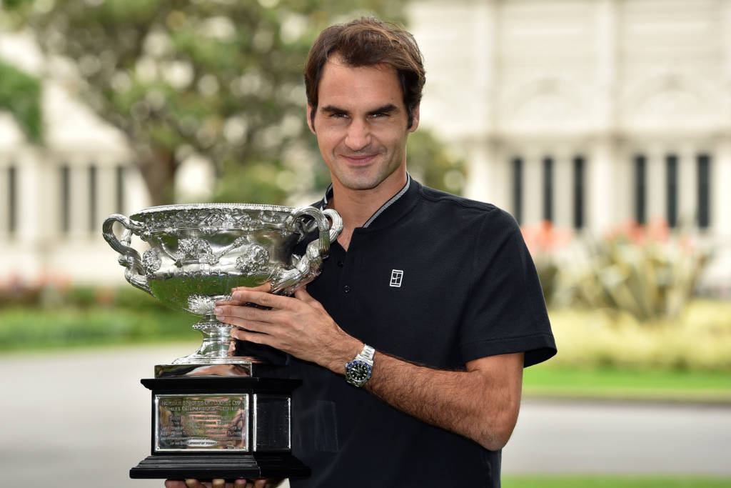 Roger Federer of Switzerland poses with the championship trophy during a photo opportunity the day after winning the Australian Open men's singles final for his 18th career Grand Slam in Melbourne on January 30, 2017. / AFP PHOTO / SAEED KHAN / IMAGE RESTRICTED TO EDITORIAL USE - STRICTLY NO COMMERCIAL USE