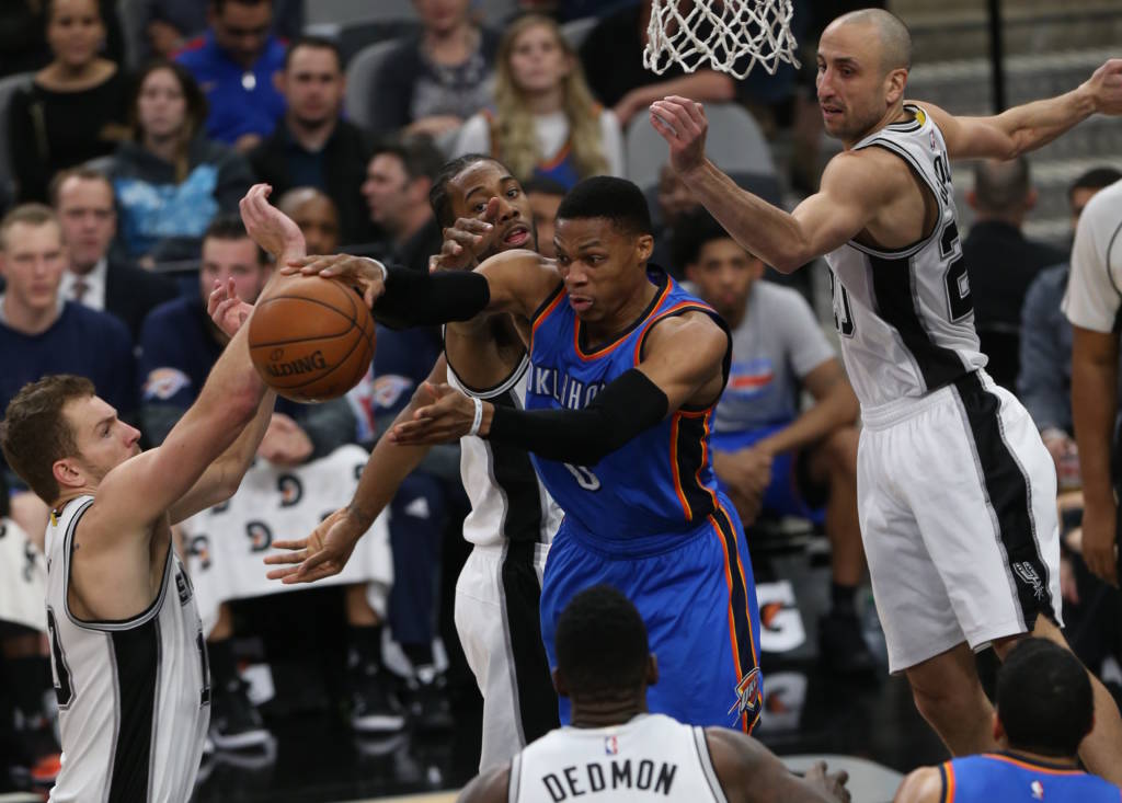 SAN ANTONIO, TX - JANUARY 31: Russell Westbrook #0 of the Oklahoma City Thunder passes the ball against the San Antonio Spurs on January 31, 2017 at the AT&T Center in San Antonio, Texas. NOTE TO USER: User expressly acknowledges and agrees that, by downloading and or using this Photograph, user is consenting to the terms and conditions of the Getty Images License Agreement. Mandatory Copyright Notice: Copyright 2017 NBAE   Layne Murdoch/NBAE via Getty Images/AFP