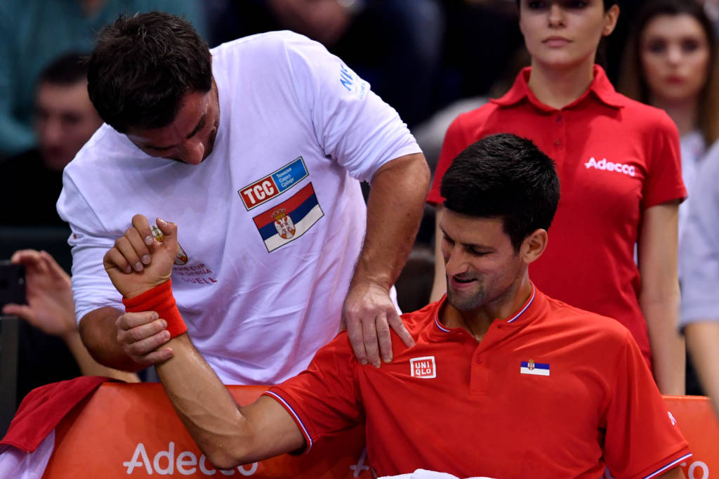 Serbia's Novak Djokovic receives medical treatment during the Davis Cup World Group first round singles tennis match between Serbia and Russia at Cair sports hall in Nis, on February 3, 2017. / AFP PHOTO / ANDREJ ISAKOVIC