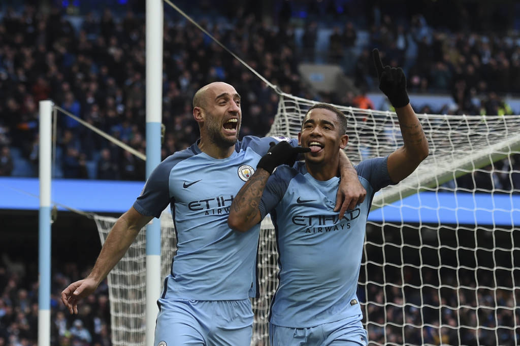 Manchester City's Brazilian striker Gabriel Jesus (R) celebrates with Manchester City's Argentinian defender Pablo Zabaleta after scoring their late winning goal during the English Premier League football match between Manchester City and Swansea City at the Etihad Stadium in Manchester, north west England, on February 5, 2017. Manchester City won the game 2-1. / AFP PHOTO / PAUL ELLIS / RESTRICTED TO EDITORIAL USE. No use with unauthorized audio, video, data, fixture lists, club/league logos or 'live' services. Online in-match use limited to 75 images, no video emulation. No use in betting, games or single club/league/player publications. /