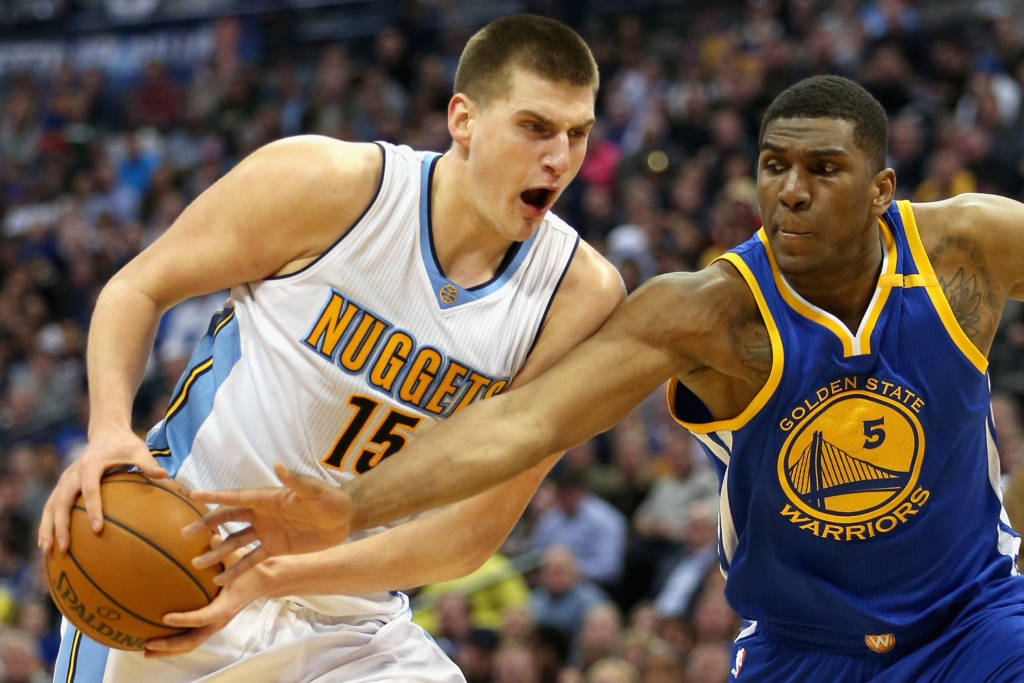 DENVER, CO - FEBRUARY 13: Nikola Jokic #15 of the Denver Nuggets drives to the basket against Kevin Looney #5 of the Golden State Warriors at the Pepsi Center on February 13, 2017 in Denver, Colorado. NOTE TO USER: User expressly acknowledges and agrees that , by downloading and or using this photograph, User is consenting to the terms and conditions of the Getty Images License Agreement.   Matthew Stockman/Getty Images/AFP