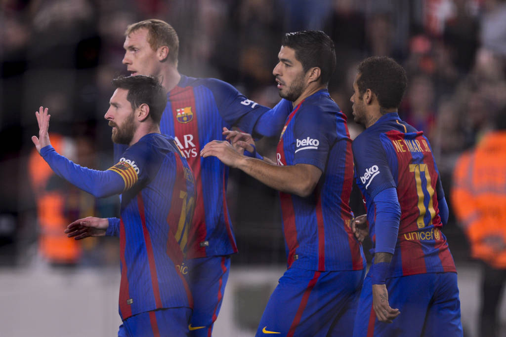 Barcelona's Argentinian forward Lionel Messi (L) is congratulated by teammates Barcelona's French defender Jeremy Mathieu (2L) and Barcelona's Uruguayan forward Luis Suarez (2R) after scoring a goal during the Spanish league football match FC Barcelona vs CD Leganes at the Camp Nou stadium in Barcelona on February 19, 2017. / AFP PHOTO / Josep Lago