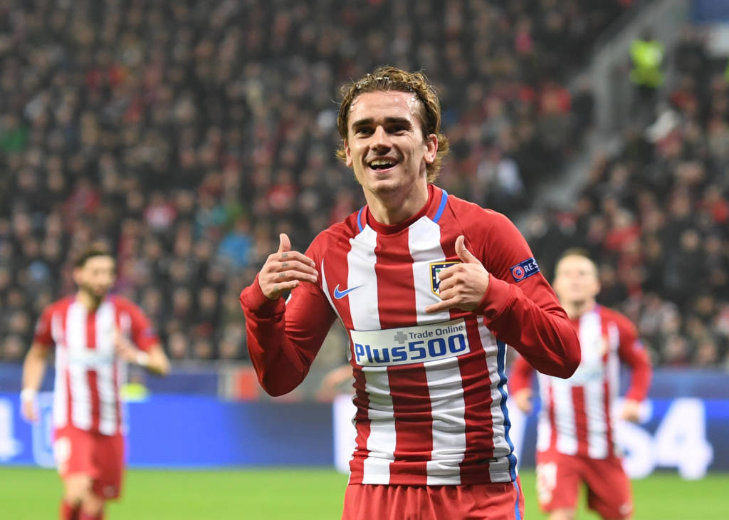 Atletico Madrid's French forward Antoine Griezmann celebrate after scoring the 0-2 goal during the UEFA Champions League round of 16 first-leg football match between Bayer 04 Leverkusen and Club Atletico de Madrid in Leverkusen, western Germany on February 21, 2017. / AFP PHOTO / dpa / Federico Gambarini / Germany OUT