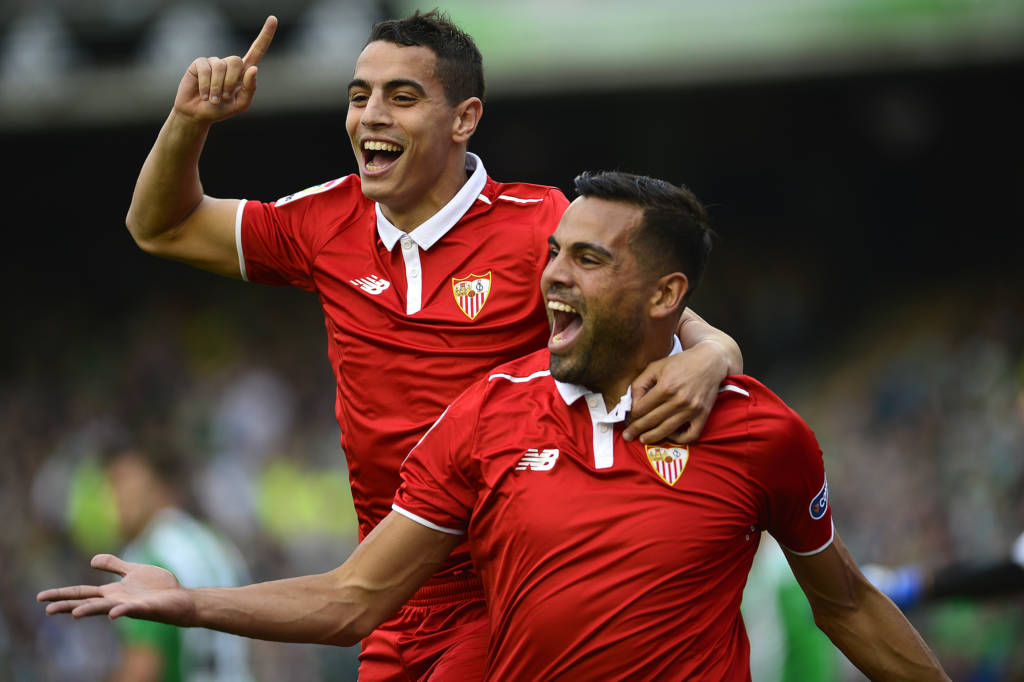 Sevilla's Argentinian defender Gabriel Mercado (R) celebrates after scoring a goal with Sevilla's French forward Wissam Ben Yedder (L) during the Spanish league football match Real Betis vs Sevilla FC at the Benito Villamarin stadium in Sevilla on February 25, 2017. / AFP PHOTO / CRISTINA QUICLER