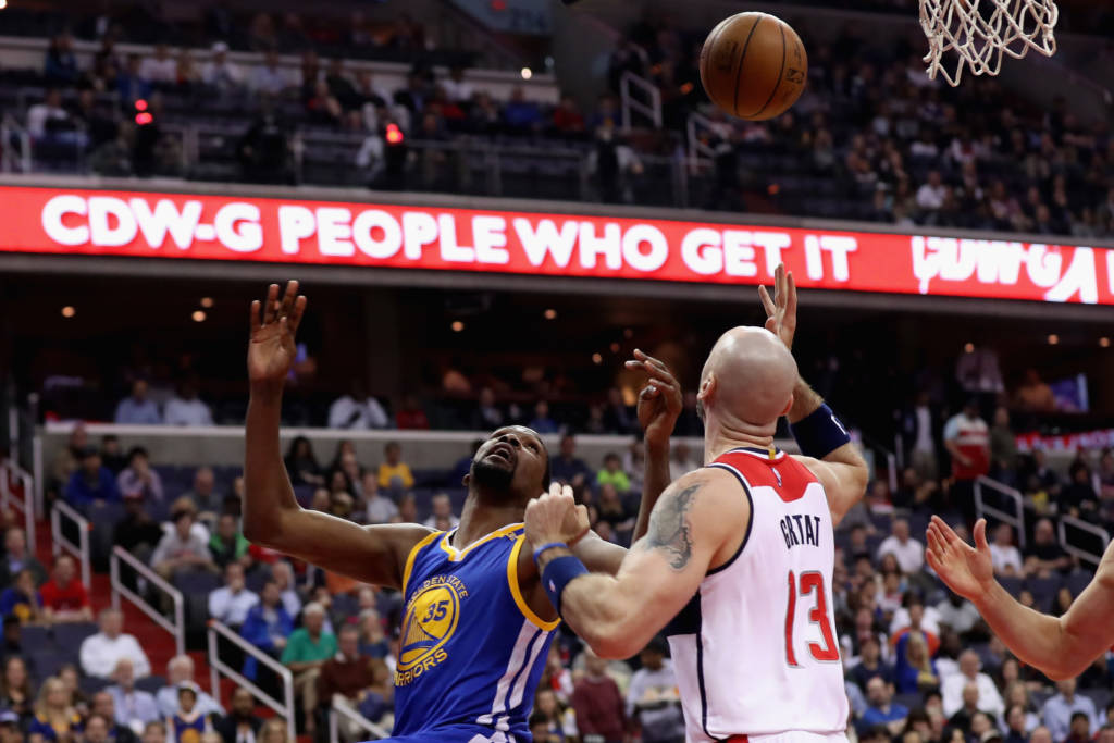 WASHINGTON, DC - FEBRUARY 28: Kevin Durant #35 of the Golden State Warriors and Marcin Gortat #13 of the Washington Wizards go up for the ball in the first half at Verizon Center on February 28, 2017 in Washington, DC. NOTE TO USER: User expressly acknowledges and agrees that, by downloading and or using this photograph, User is consenting to the terms and conditions of the Getty Images License Agreement. Rob Carr/Getty Images/AFP