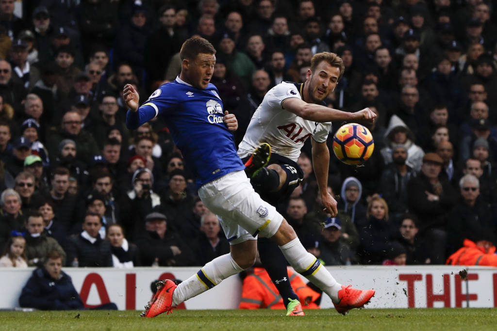 Tottenham Hotspur's English striker Harry Kane (R) shoots past Everton's Scottish-born Irish midfielder James McCarthy during the English Premier League football match between Tottenham Hotspur and Everton at White Hart Lane in London, on March 5, 2017. / AFP PHOTO / Adrian DENNIS / RESTRICTED TO EDITORIAL USE. No use with unauthorized audio, video, data, fixture lists, club/league logos or 'live' services. Online in-match use limited to 75 images, no video emulation. No use in betting, games or single club/league/player publications. /