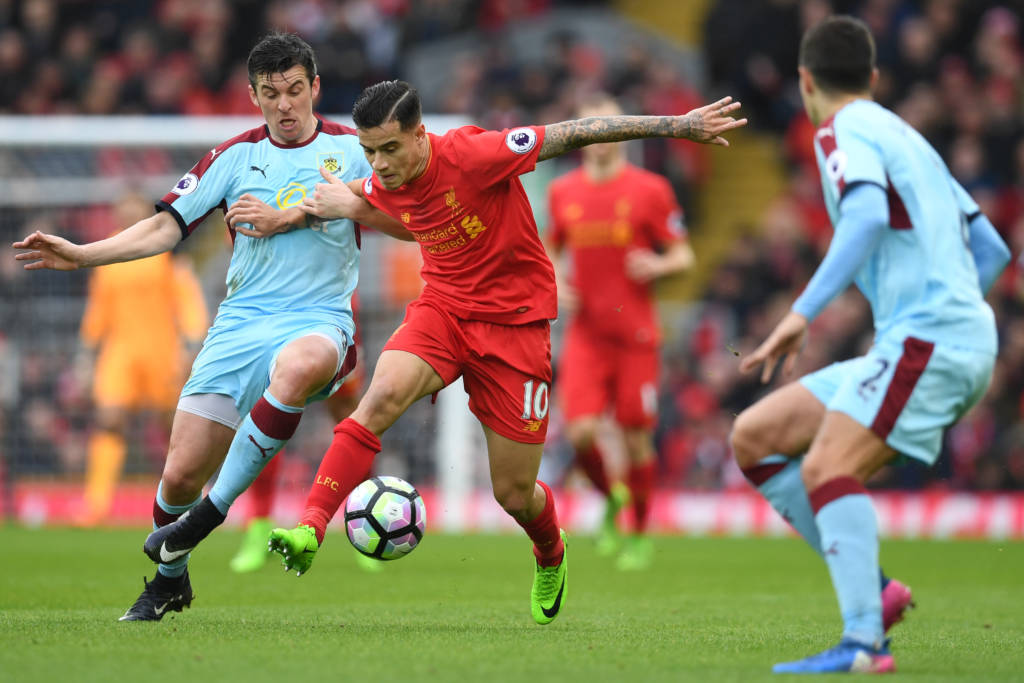 Burnley's English midfielder Joey Barton (L) vies with Liverpool's Brazilian midfielder Philippe Coutinho during the English Premier League football match between Liverpool and Burnley at Anfield in Liverpool, north west England on March 12, 2017. / AFP PHOTO / Paul ELLIS / RESTRICTED TO EDITORIAL USE. No use with unauthorized audio, video, data, fixture lists, club/league logos or 'live' services. Online in-match use limited to 75 images, no video emulation. No use in betting, games or single club/league/player publications.  /