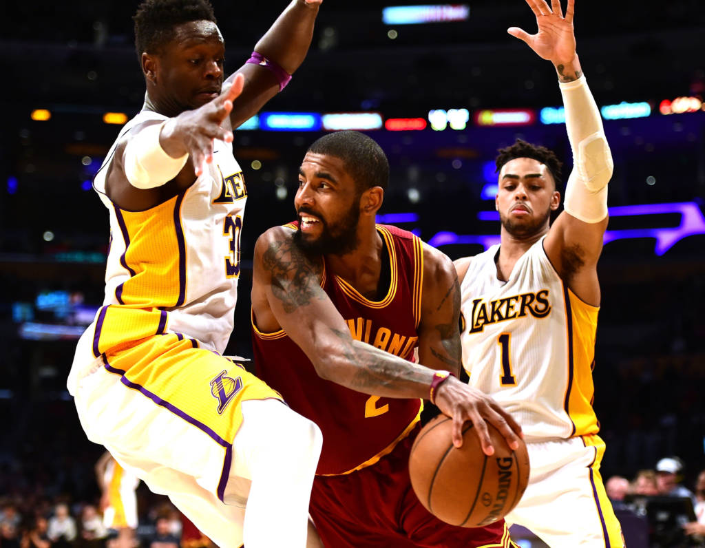 LOS ANGELES, CA - MARCH 19: Kyrie Irving #2 of the Cleveland Cavaliers passes out of a double team from Julius Randle #30 and D'Angelo Russell #1 of the Los Angeles Lakers during a 125-120 Cavaliers win at Staples Center on March 19, 2017 in Los Angeles, California. NOTE TO USER: User expressly acknowledges and agrees that, by downloading and or using this photograph, User is consenting to the terms and conditions of the Getty Images License Agreement. Harry How/Getty Images/AFP