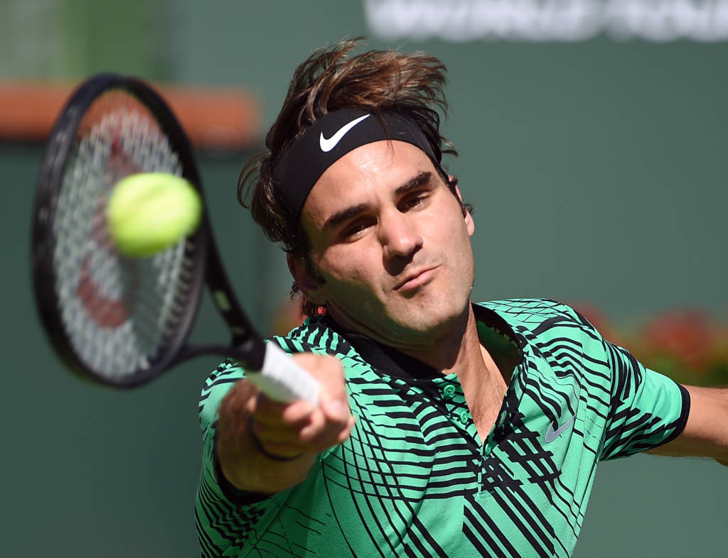 INDIAN WELLS, CA - MARCH 19: Roger Federer of Switzerland hits a forehand volley against Stanislas Wawrinka of Switzerland in the men's final during day fourteen of the BNP Paribas Open at Indian Wells Tennis Garden on March 19, 2017 in Indian Wells, California.  Kevork Djansezian/Getty Images/AFP